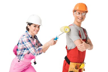 Woman construction worker painting man with paint roller isolated on white clipart