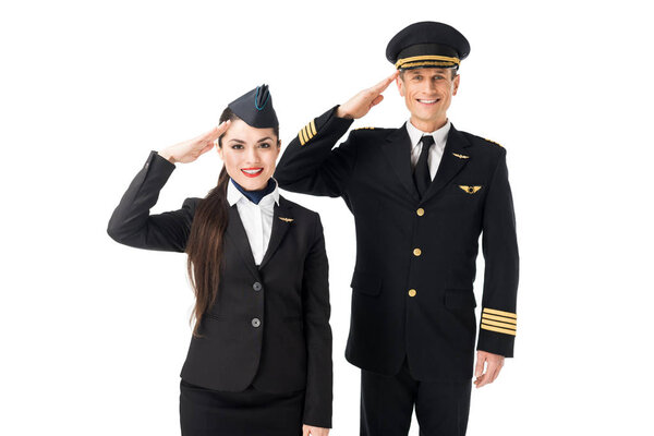 Young stewardess and pilot saluting isolated on white