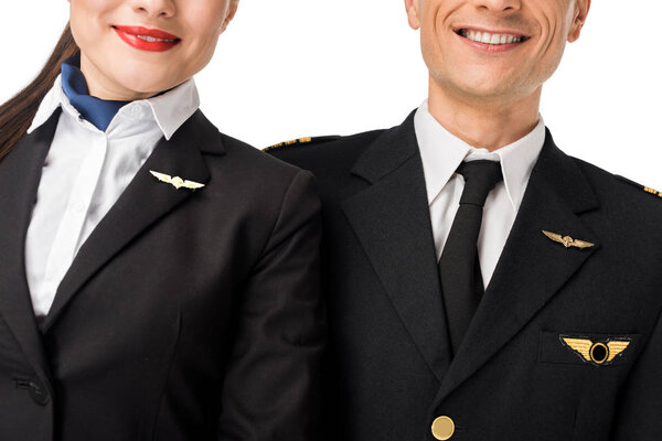 Close-up view of stewardess and pilot in uniform isolated on white