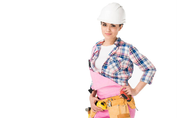Smiling female engineer in pink overalls isolated on white