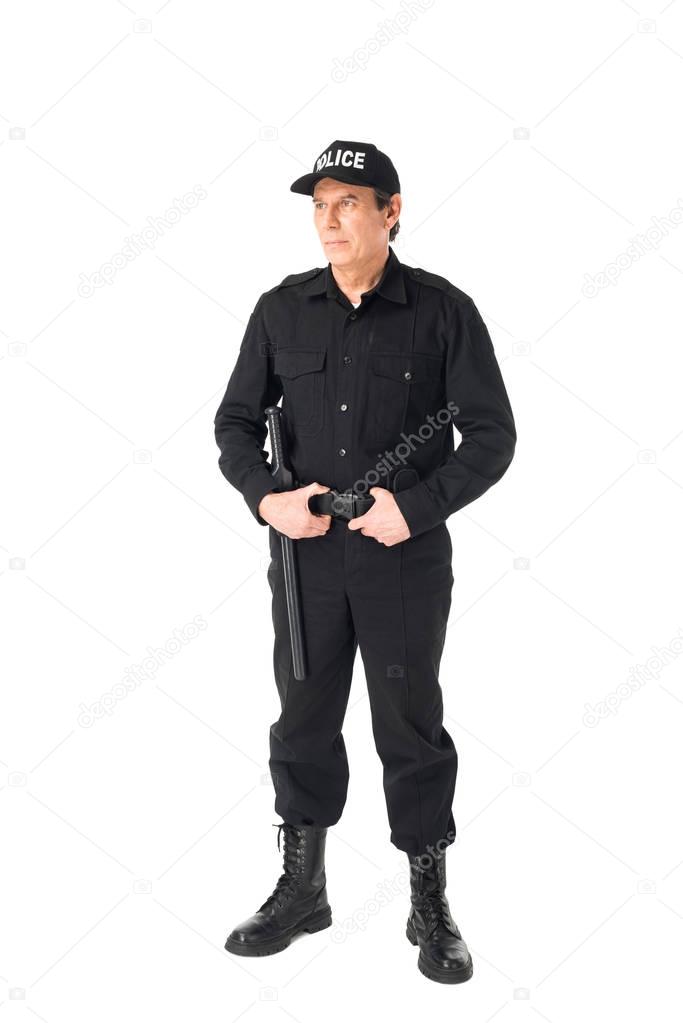 Confident policeman in uniform holding belt isolated on white
