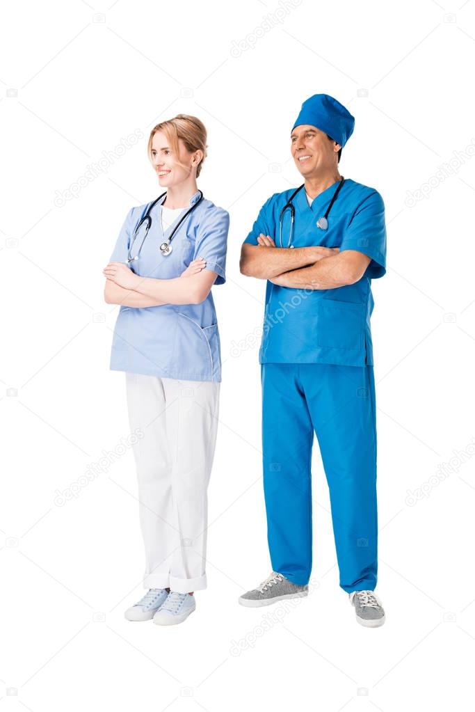 Surgeon and nurse with arms folded isolated on white