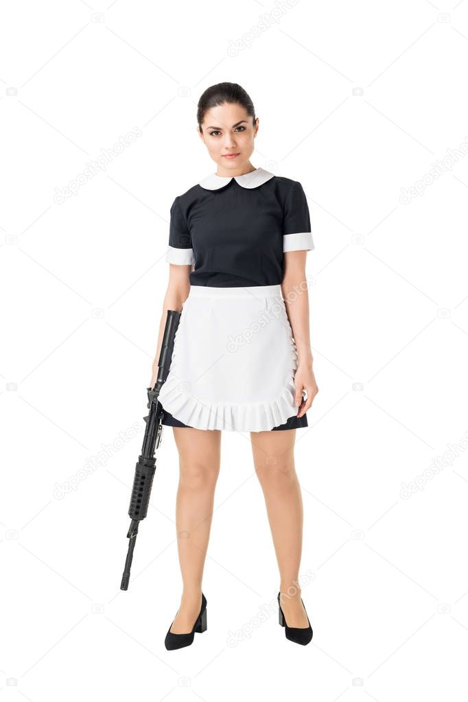 Confident woman in maid uniform holding rifle isolated on white