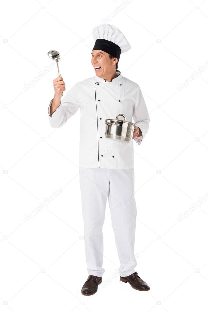 Smiling chef with pan and ladle isolated on white