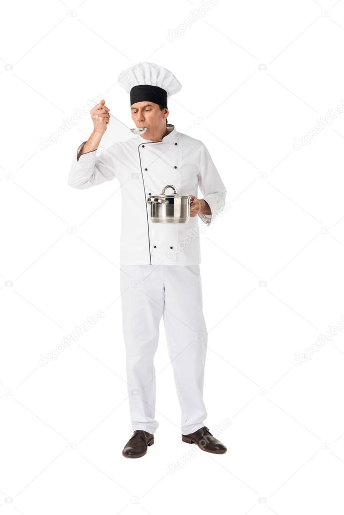 Smiling chef with pan tasting food isolated on white