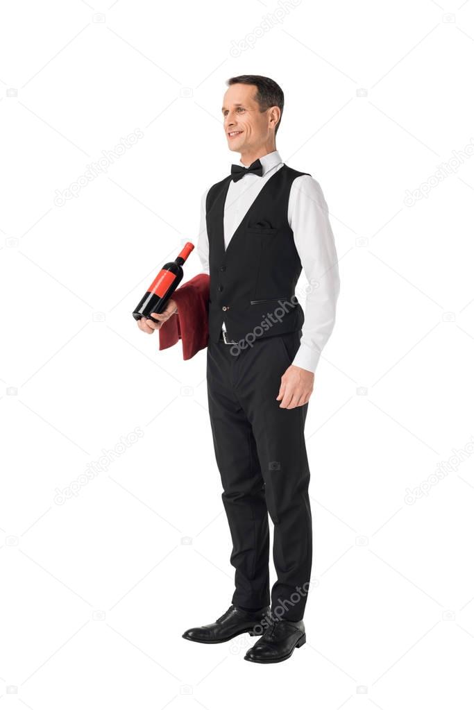 Male waiter serving bottle with wine isolated on white