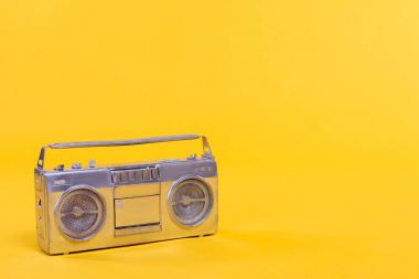 close-up view of trendy silver tape recorder isolated on yellow clipart