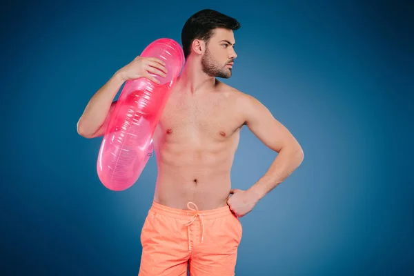 Handsome Young Man Shorts Holding Inflatable Ring Looking Away Blue — Stock Photo, Image