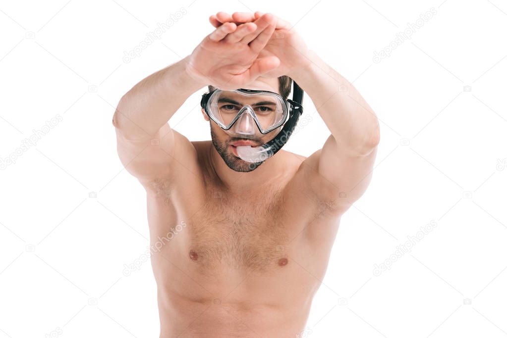 handsome shirtless young man in diving mask swimming and looking at camera isolated on white  