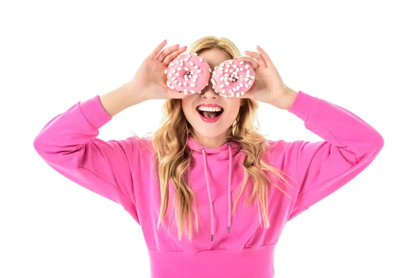 Блондинка Розовой Одежде Держит Пончики Перед Глазами Изолированными Белом — стоковое фото