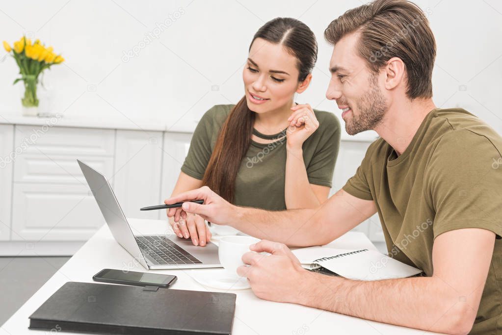attractive young couple working together at home