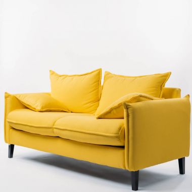 studio shot of yellow couch with pillows, on white clipart