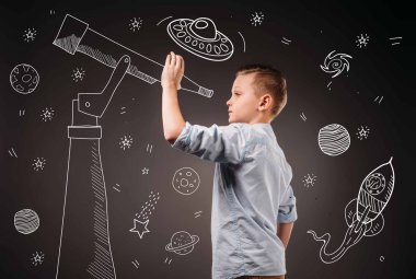 preteen boy pretending to be a astronomer with drawn telescope and UFO, planets, spaceship and stars icons clipart