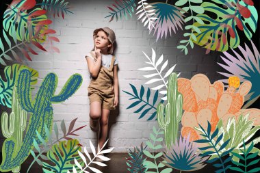pensive child in safari costume standing at white wall with cactuses illustration clipart