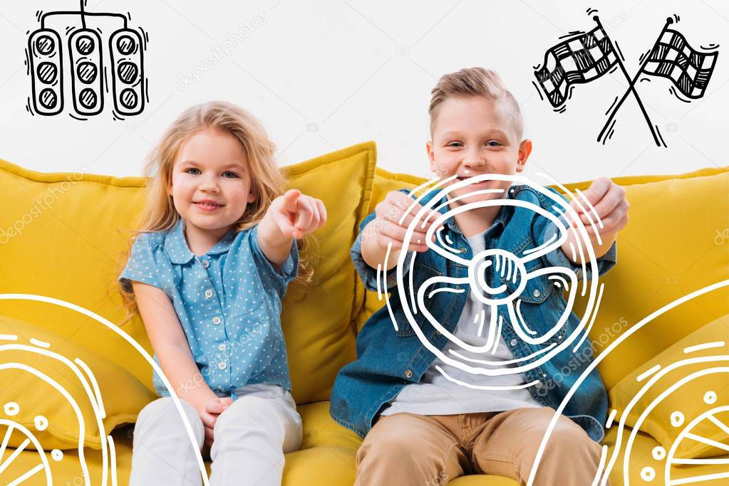little boy driving drawn car and sister pointing while sitting on yellow sofa 