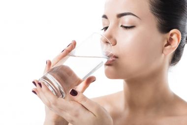 beautiful girl drinking water from transparent glass isolated on white clipart