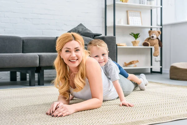 Little Son Laying Smiling Mother Back Modern Living Room — Stock Photo, Image