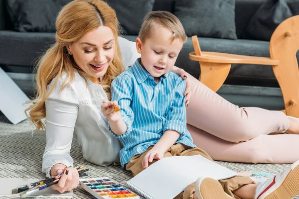 Mother Embracing Little Son While Painting — Stock Photo, Image