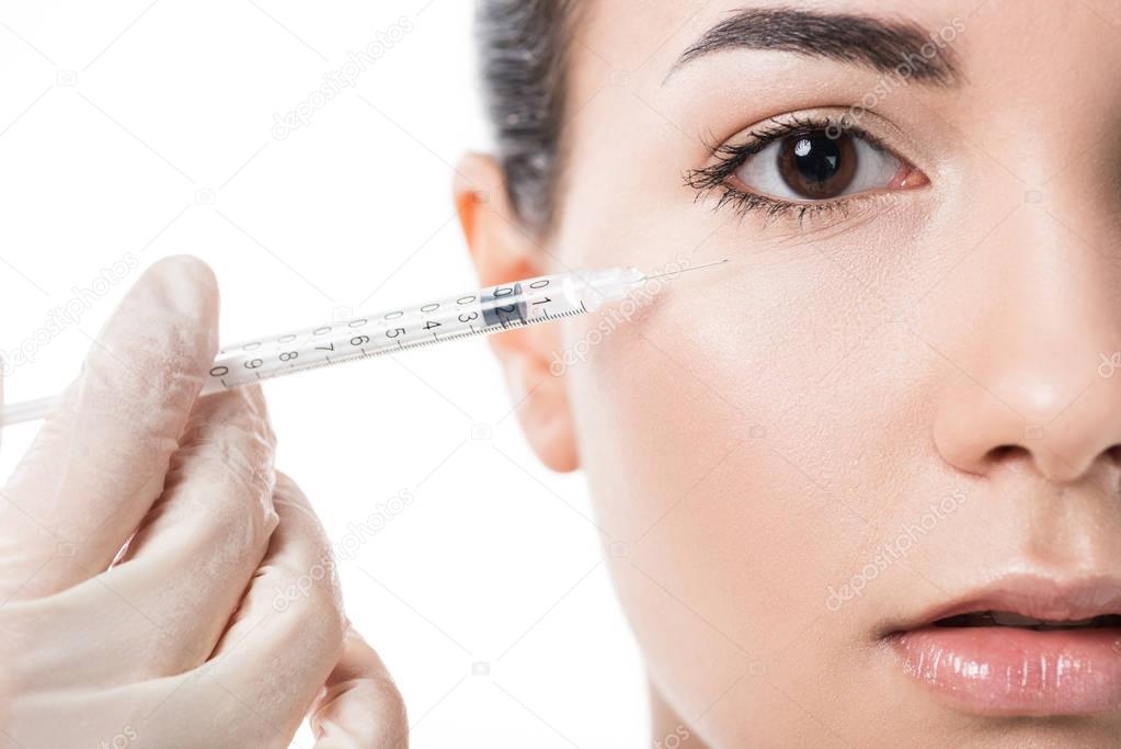 cropped image of cosmetologist making beauty injection to girl with clean skin isolated on white