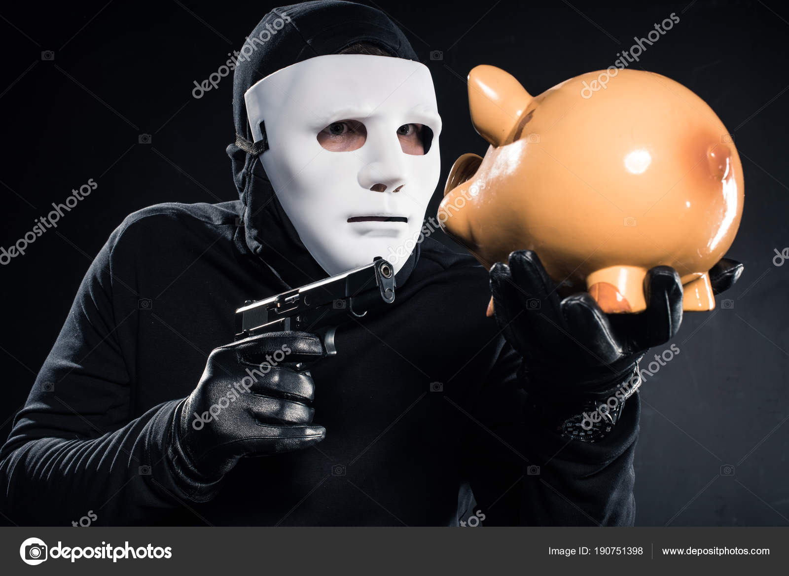 Robber Balaclava Mask Aiming Piggy Bank Stock Photo by ©EdZbarzhyvetsky