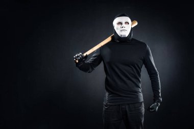 Burglar in mask and balaclava holding baseball bat clipart