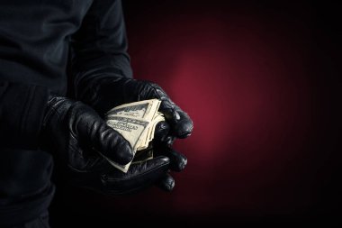 Man in black gloves holding dollar banknotes  clipart