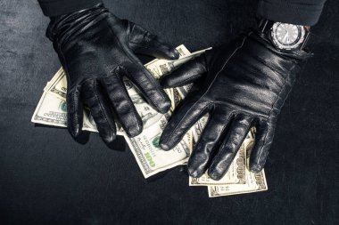 Male hands in black gloves grabbing dollars clipart