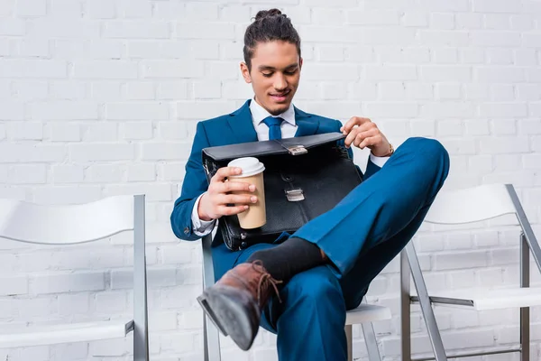 Businessman Sitting Chair Waiting Coffee Cup Briefcase Hands — Free Stock Photo