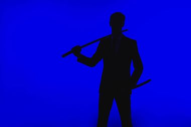 toned picture of silhouette of agent in suit with Katana clipart