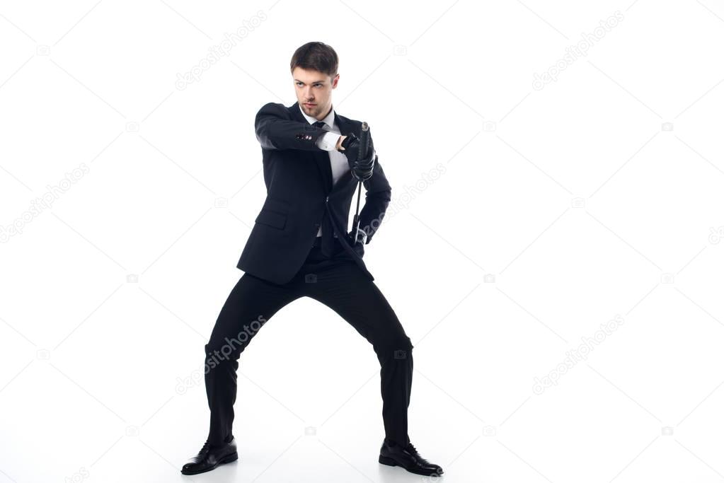 confident agent in suit and gloves with katana isolated on white