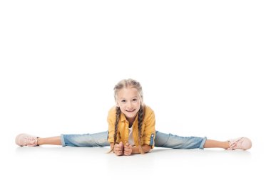 smiling little child stretching, doing split and looking at camera isolated on white clipart