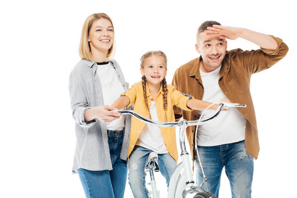 portrait of smiling parents and little daughter on bicycle isolated on white