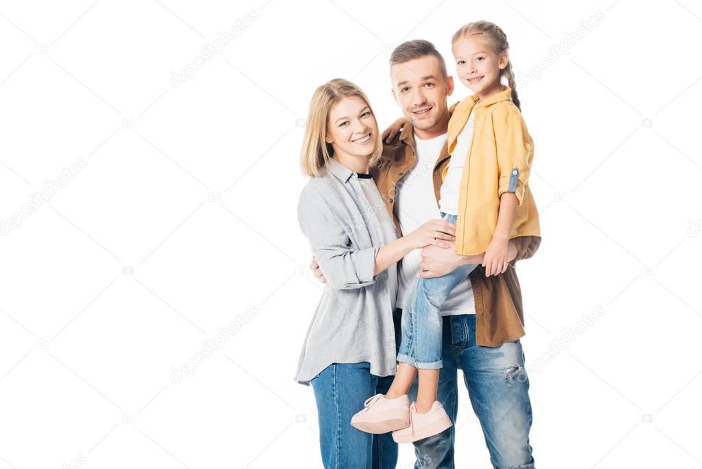 smiling man holding cute daughter with wife standing near by isolated on white
