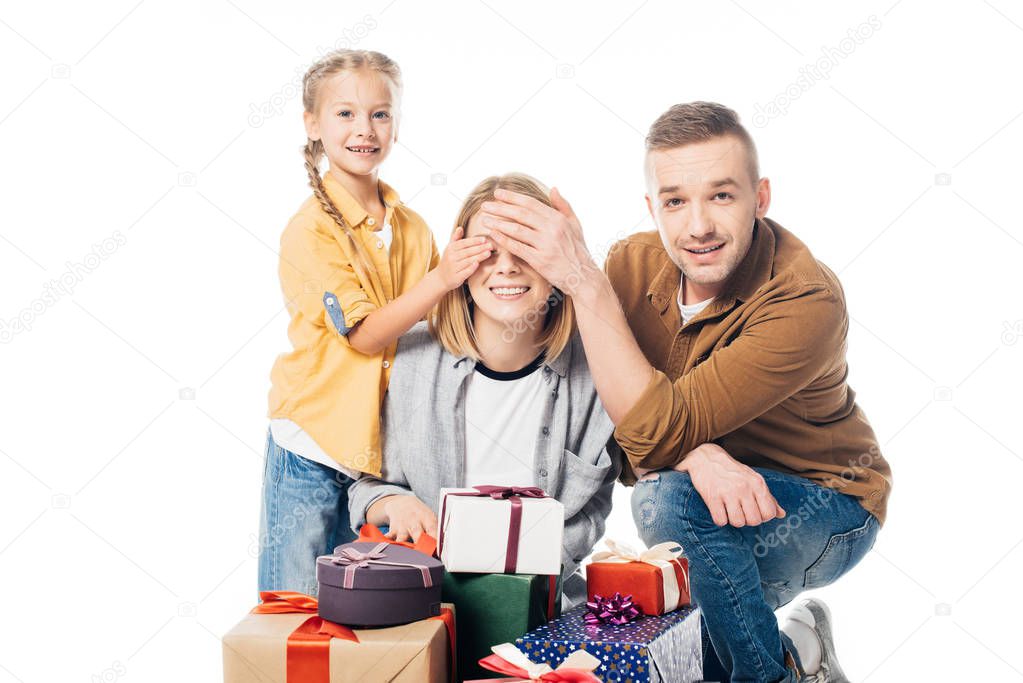 man and kid covering mothers eyes to make surprise isolated on white