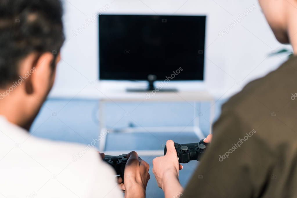 cropped shot of couple playing video game together at home