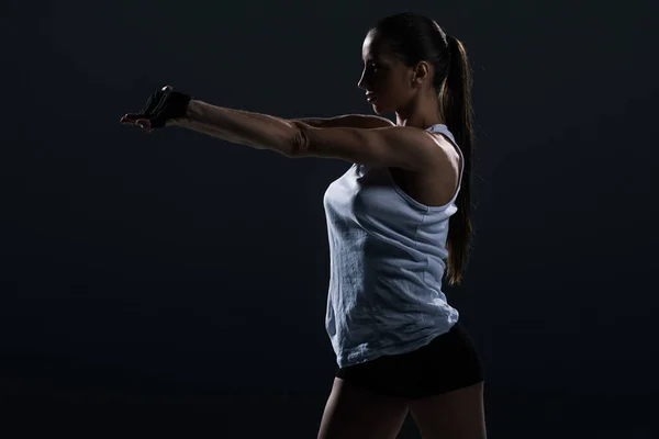 Attractive Strong Female Bodybuilder Stretching Arms Isolated Black — Free Stock Photo