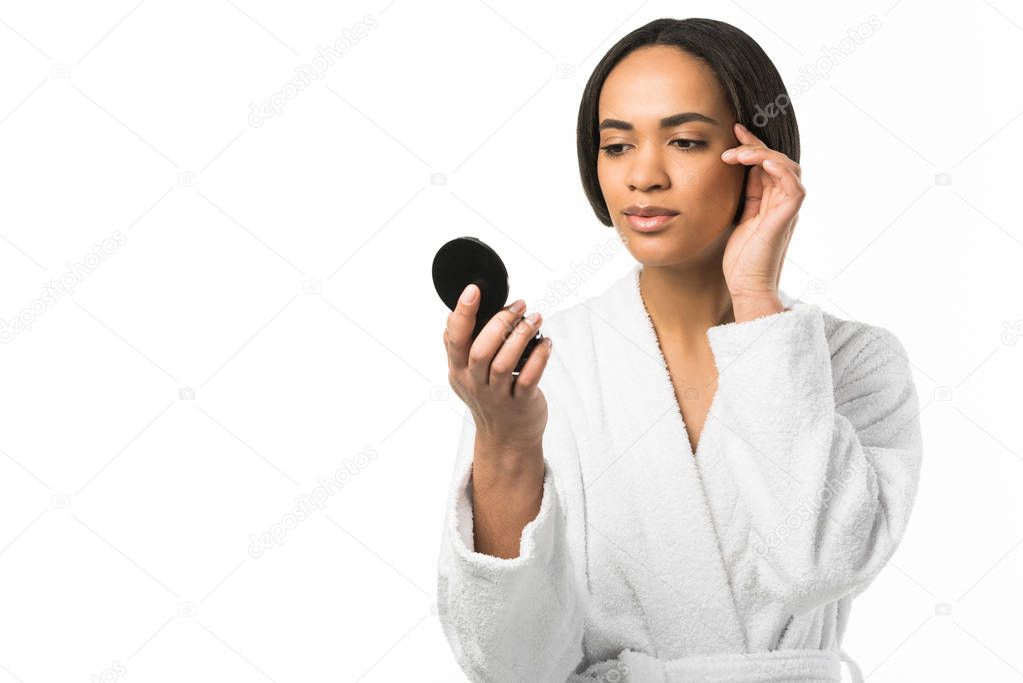 african american girl with perfect clean skin looking at mirror,  isolated on white