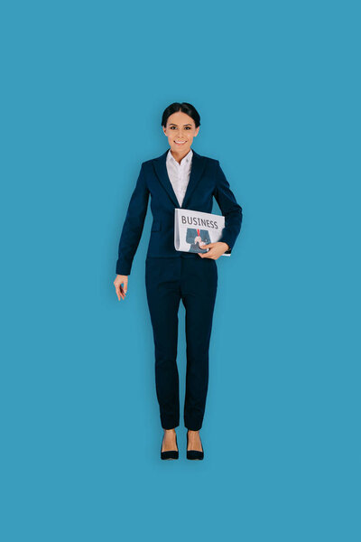 Top view of businesswoman with newspaper isolated on blue background
