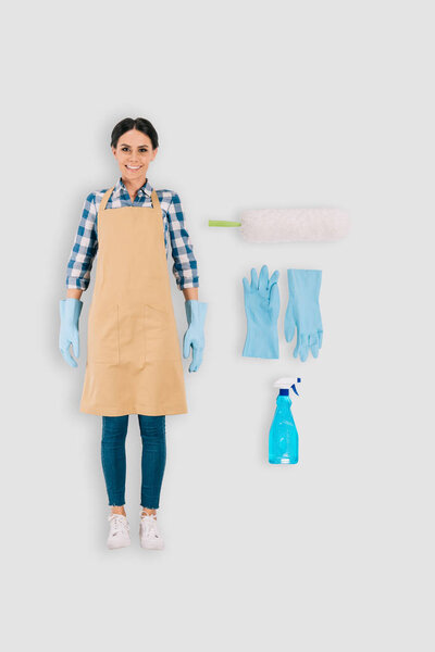 top view of female cleaner in protective gloves with spray bottle and duster isolated on white background