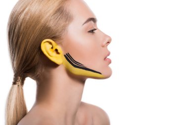 side view of attractive woman with yellow and black paints on ear and face isolated on white clipart