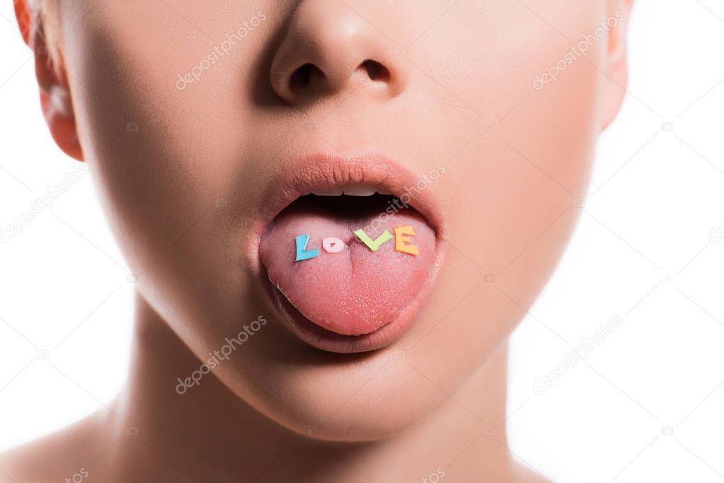 cropped image of woman sticking tongue out with word love isolated on white