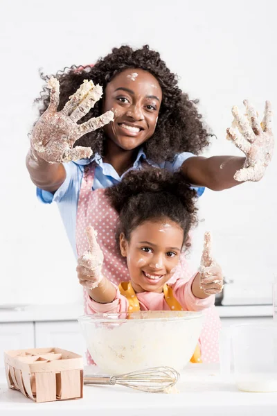 Smiling African American Mother Funny Daughter Showing Hands Dough Thumbs — Stock Photo, Image