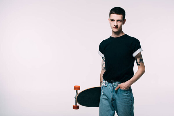 Hipster young man holding longboard isolated on white