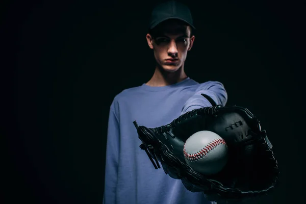 Guy Wearing Baseball Mitt Showing Baseball Ball Isolated Black — Free Stock Photo