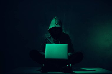 dizüstü bilgisayar kullanarak hoodie hacker silüeti tonda resmi