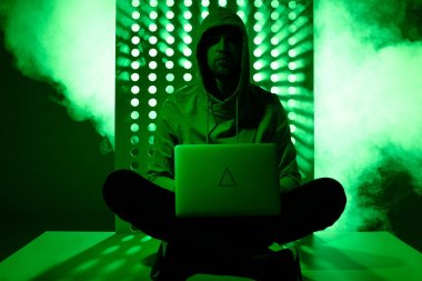 hacker hoodie üzerinde laptop ve üçgen işareti olan'ı tonda resmi