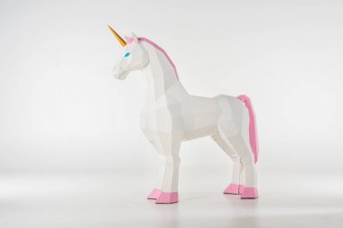unicorn toy with golden horn with pink hooves on white clipart