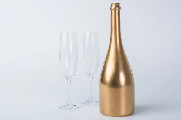 Golden Bottle Champagne Empty Glasses White Surface — Stock Photo, Image