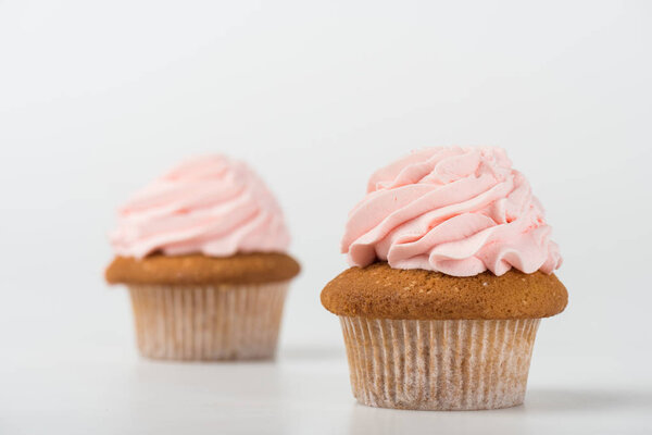 two tasty cooked pink cupcakes on white