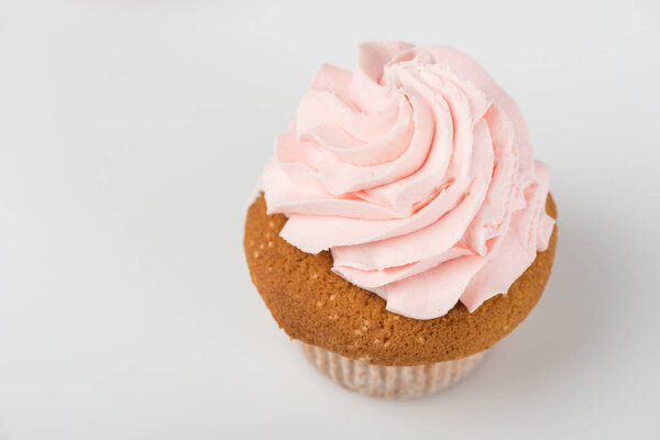one tasty cooked pink cupcake on white